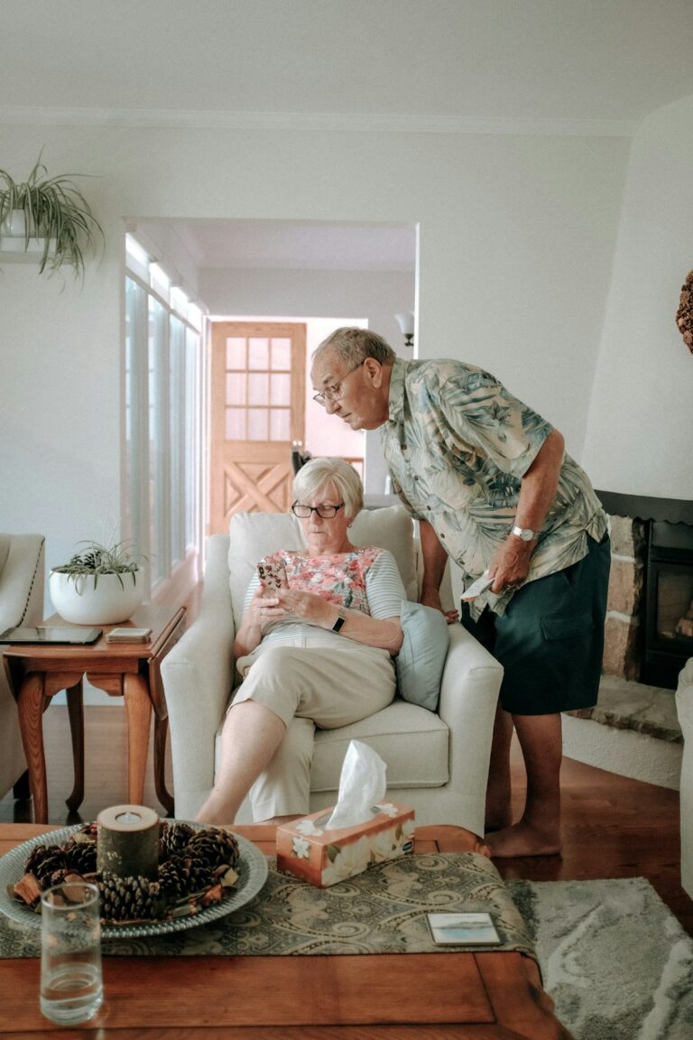 An older adult using a walker walking safely on a clear, well-lit path inside a home.